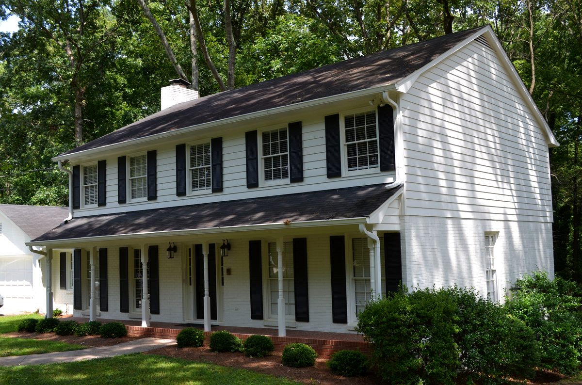 Side exterior showing mature tree canopy