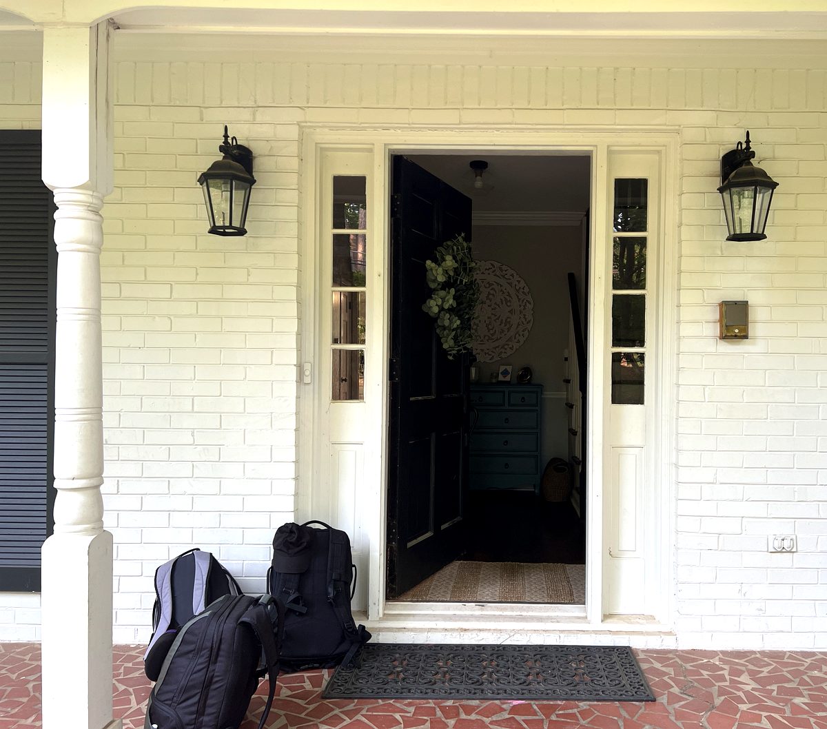 Covered front porch with lanterns and welcoming entry